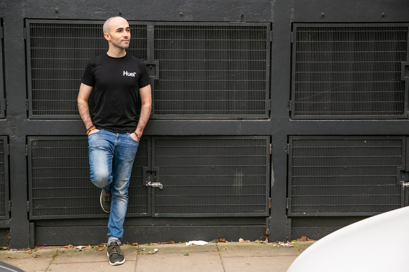 Tom leaning against a dark wall, reflective and unguarded, the quiet side of ADHD masking